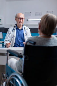 Doctor talking with patient in clinic