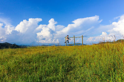 Man standing on field against sky