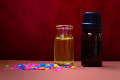 Close-up of multi colored bottles on table