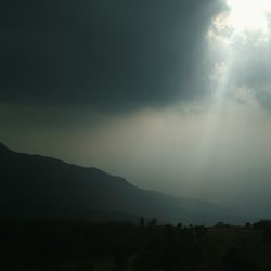 Scenic view of silhouette mountains against sky