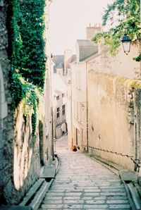 Footpath amidst buildings in a town