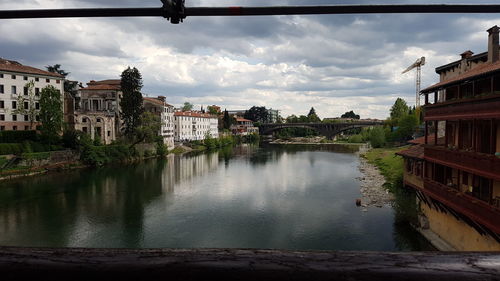 View of houses in town against cloudy sky