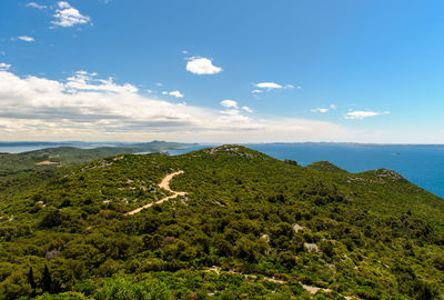 Scenic view of sea and mountains against sky