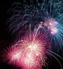 Low angle view of firework display at night