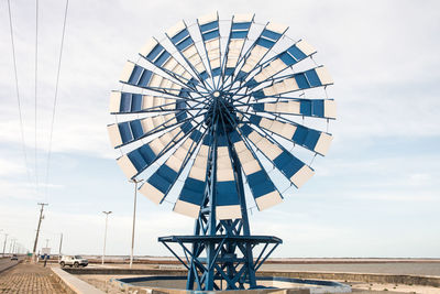 Low angle view of ferris wheel against sky