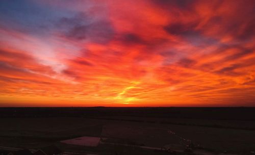 Scenic view of dramatic sky over land