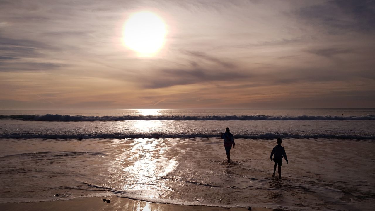 SILHOUETTE PEOPLE AT BEACH DURING SUNSET