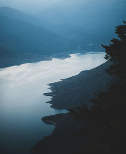 Scenic view of sea and mountains against sky