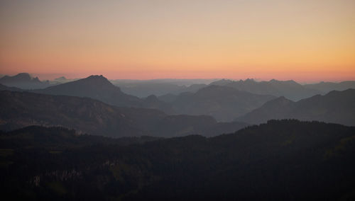 Scenic view of silhouette mountains against sky during sunset