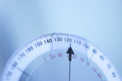 Close-up of gauge against blue background