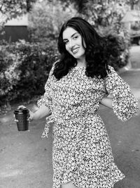 Portrait of a smiling young woman standing outdoors