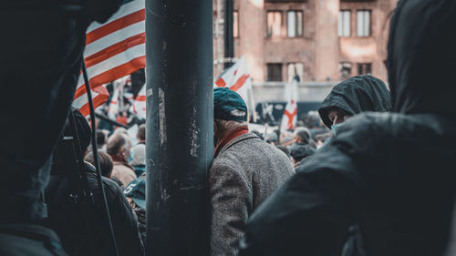 Rear view of people on street in city