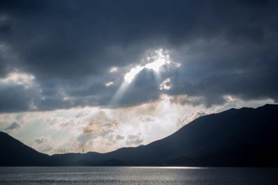 Scenic view of mountains against cloudy sky