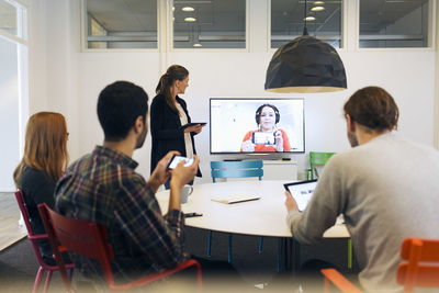 Creative business team attending conference call in board room