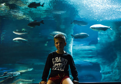 Boy swimming in sea at aquarium