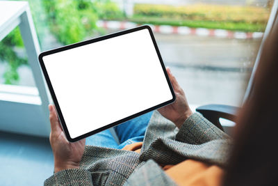 Top view mockup image of a business woman holding digital tablet with blank white desktop screen