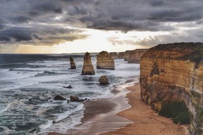 Scenic view of twelve apostles sea rocks and sea against cloudy sky