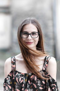 Young brown-haired millennial with glasses and light dress