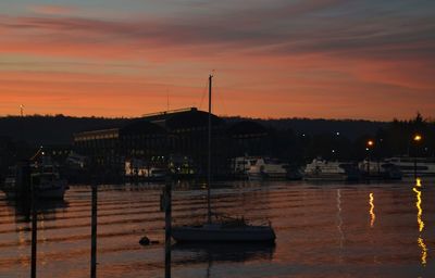 Boats in harbor at sunset