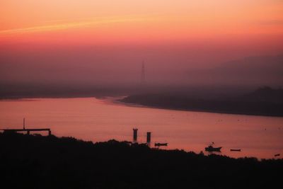 Scenic view of silhouette orange sky during sunset