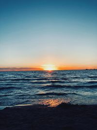 Scenic view of sea against clear sky during sunset