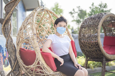 Asian girl wearing a mask detained and happy at home ,stay home away from society, new normal.