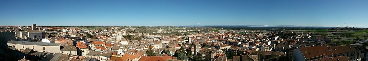 clear sky, copy space, building exterior, architecture, built structure, blue, crowded, high angle view, residential district, cityscape, residential structure, city, residential building, house, town, panoramic, townscape, roof, landscape, day