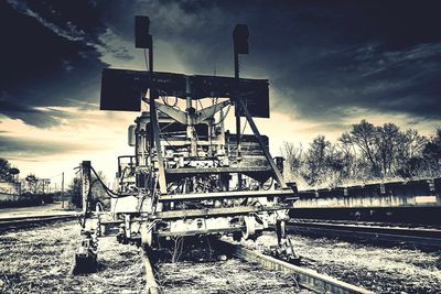 Railroad tracks by trees against sky