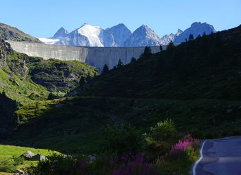 Scenic view of land and mountains against sky