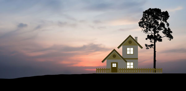 Low angle view of silhouette house against sky during sunset