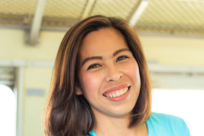 Portrait of smiling woman in train