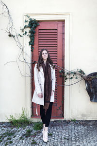 Beautiful young woman in a beige coat on the street. spring or fall outdoor portrait