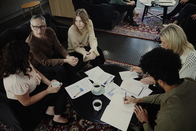 Group of business people having meeting in lobby