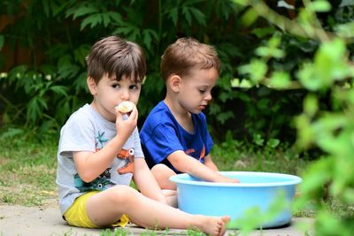 Cute brothers sitting outdoors