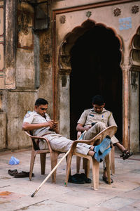 People sitting outside building