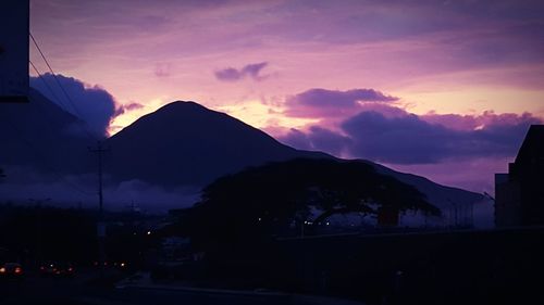 Scenic view of silhouette mountains against sky at sunset