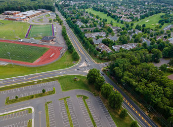 High angle view of road amidst trees in city