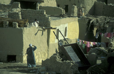 Rear view of man sitting on steps