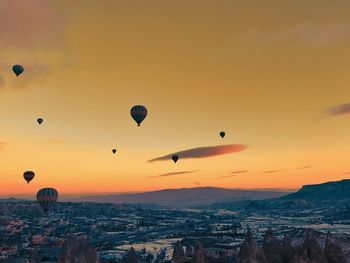 Hot air balloons flying in sky during sunset