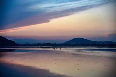 Scenic view of beach against sky during sunset