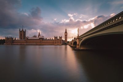 View of bridge over river against cloudy sky