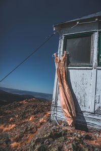 Abandoned clothes drying on clothesline against sky