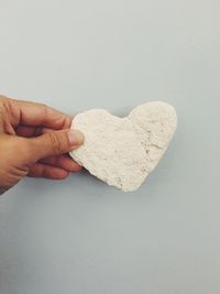 Close-up of hand holding heart shape cookies