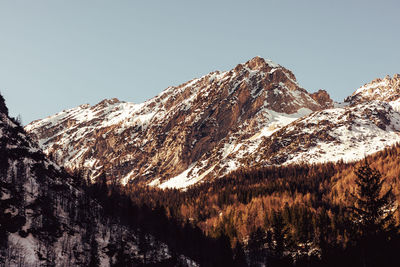 Scenic view of snowcapped mountains against clear sky