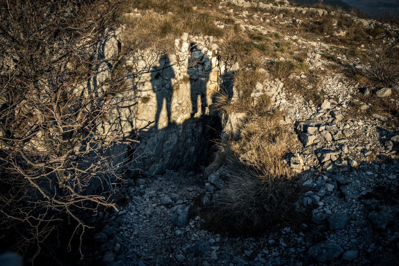 HIGH ANGLE VIEW OF SHADOW ON ROCK IN SUNLIGHT