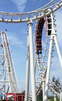 Low angle view of amusement park ride against sky