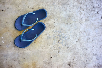 High angle view of blue flip-flops on street