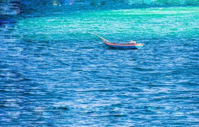 Boat swimming in sea