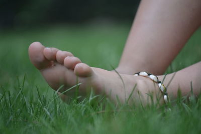 Low section of woman on field