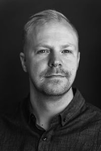 Close-up portrait of man against black background